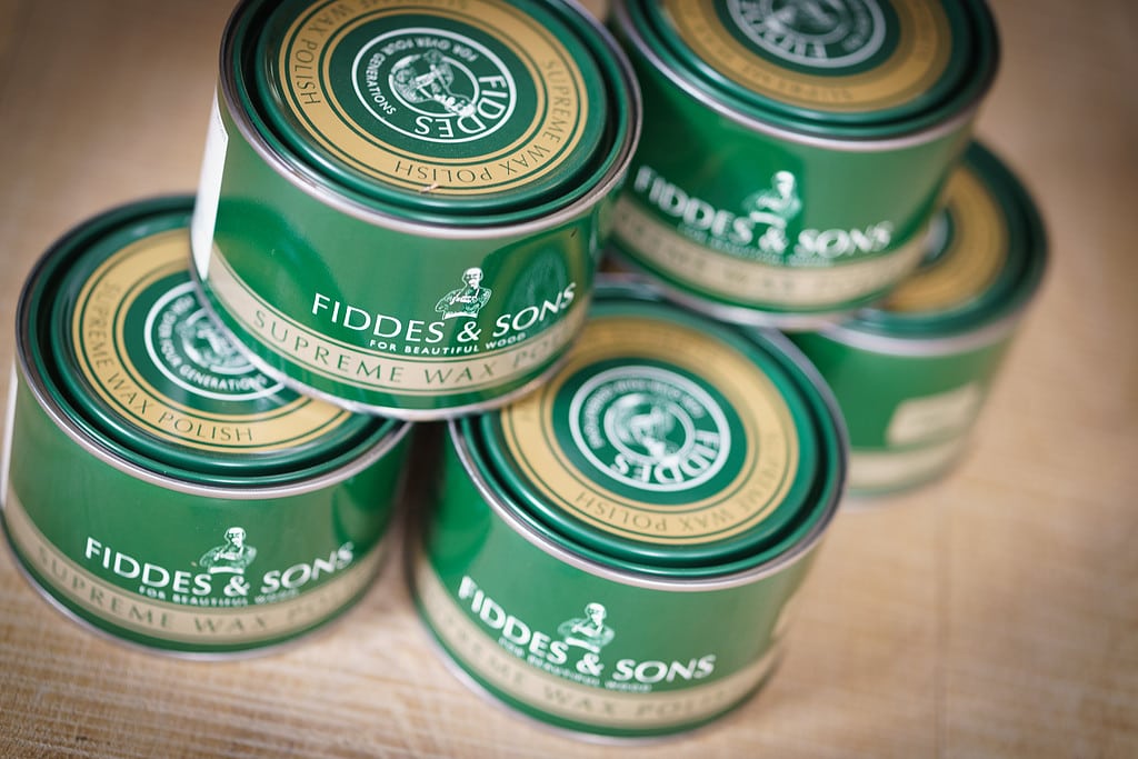 A stack of furniture wax by Fiddes wood finishes
