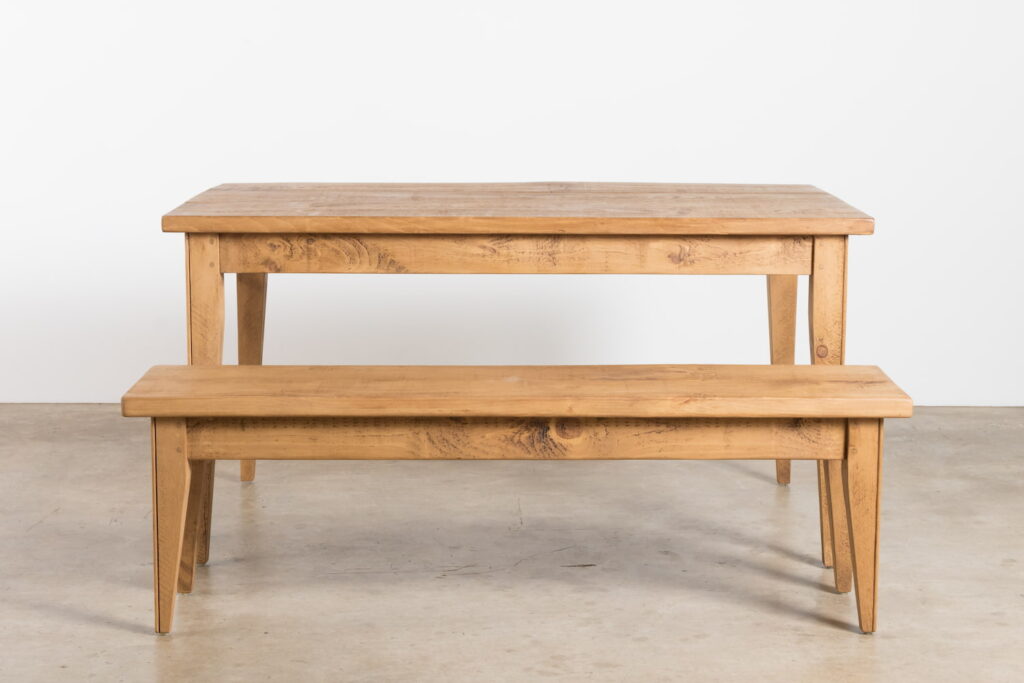 A solid wood dining table and bench