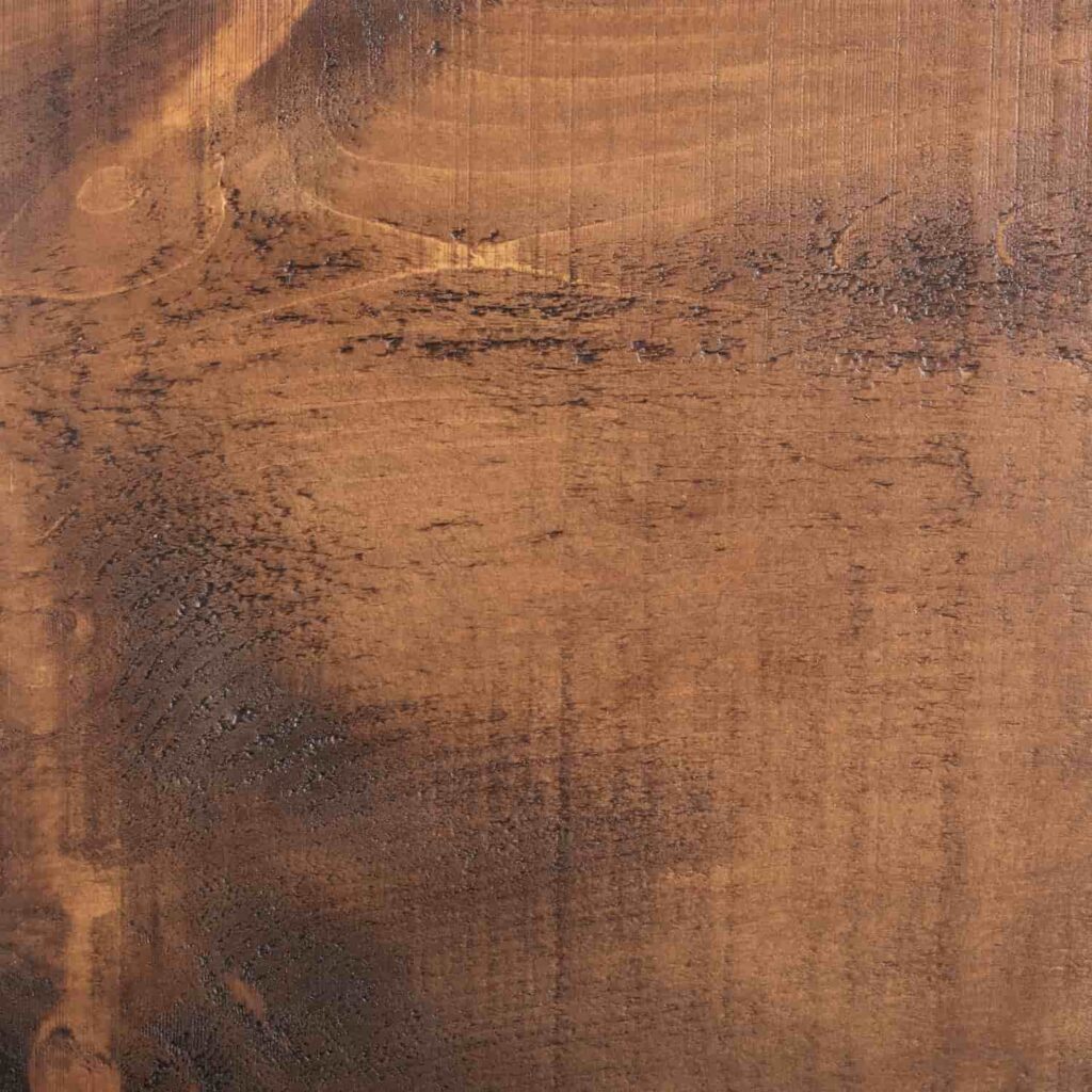 A close up of a piece of wood showing the Dark finish from the Ashton & Coleman Mill Sawn Pine furniture range