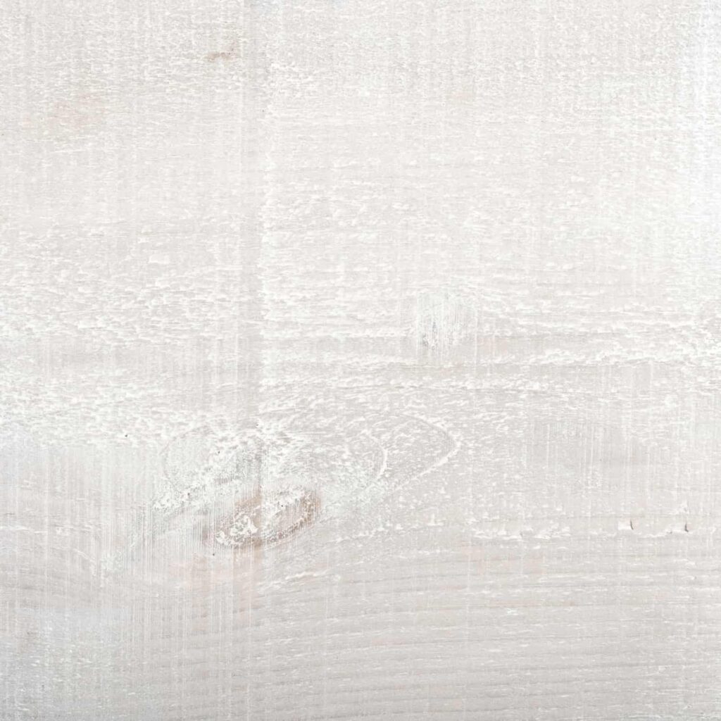 A close up of a piece of wood showing the Driftwood finish from the Ashton & Coleman Mill Sawn Pine furniture range