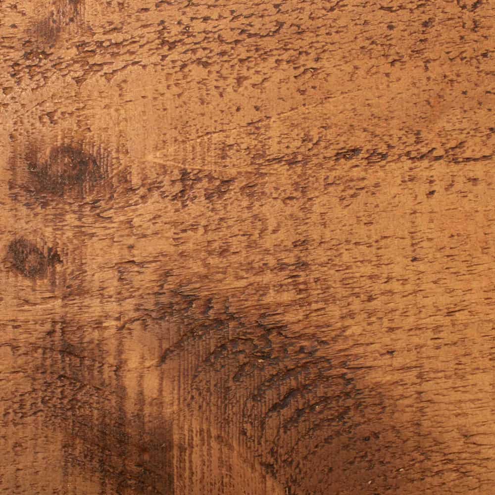 A close up of a wooden bedpost that features unique character in the knots and wood grain.